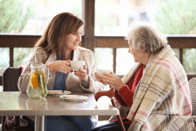 elder woman and caregiver drinking tea