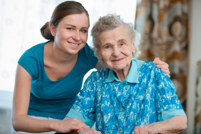 caregiver and elder lady in blue clothing